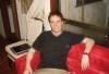 Living in Japan - Sven reclining on a sofa in the common area of the gaijin house