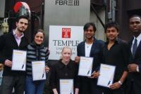 The winning team with their certificates and classmate Dollar